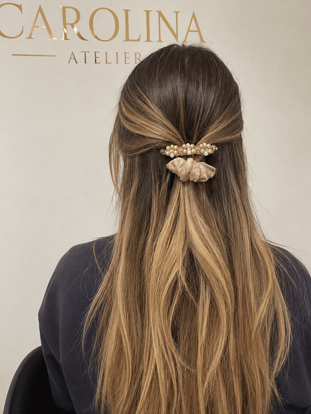 Pinza de perlas con scrunchie rosado en un peinado semirrecogido
